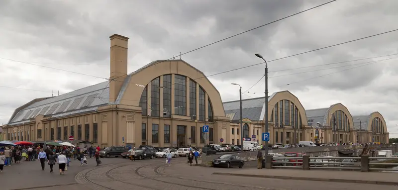 The vast zeppelin-hangar pavilions of Riga Central Market, with market stalls and shoppers in the foreground