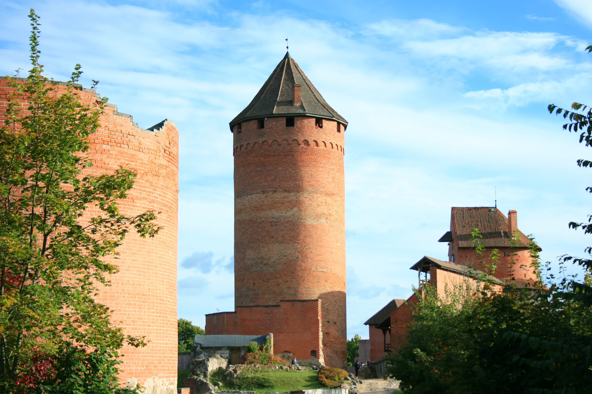 Turaida Castle near Sigulda, a red-brick medieval castle with a tall cylindrical tower on a wooded hill